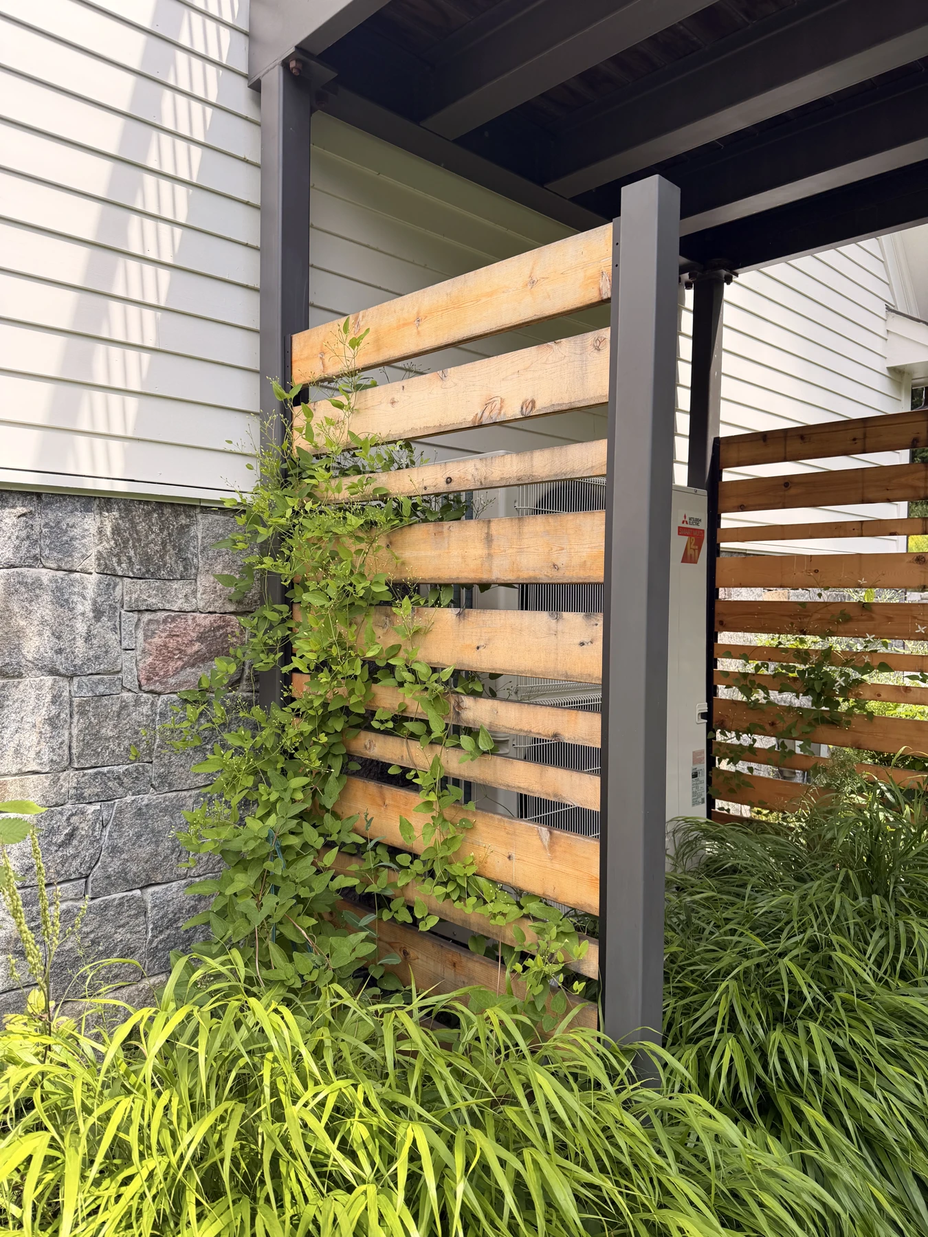 Garden screens conceal utilities and support climbing plants.