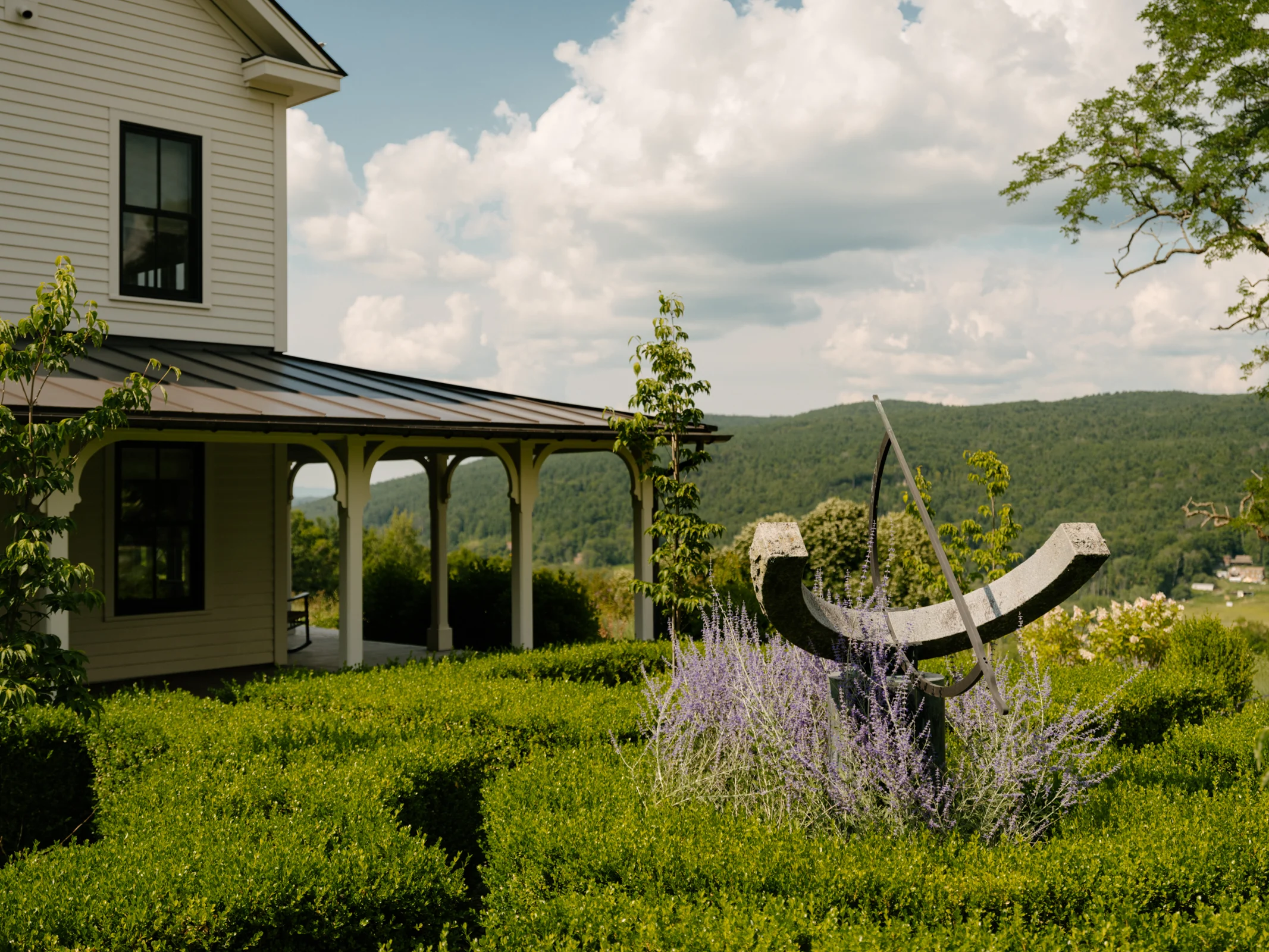 The porch opens onto the planted garden.